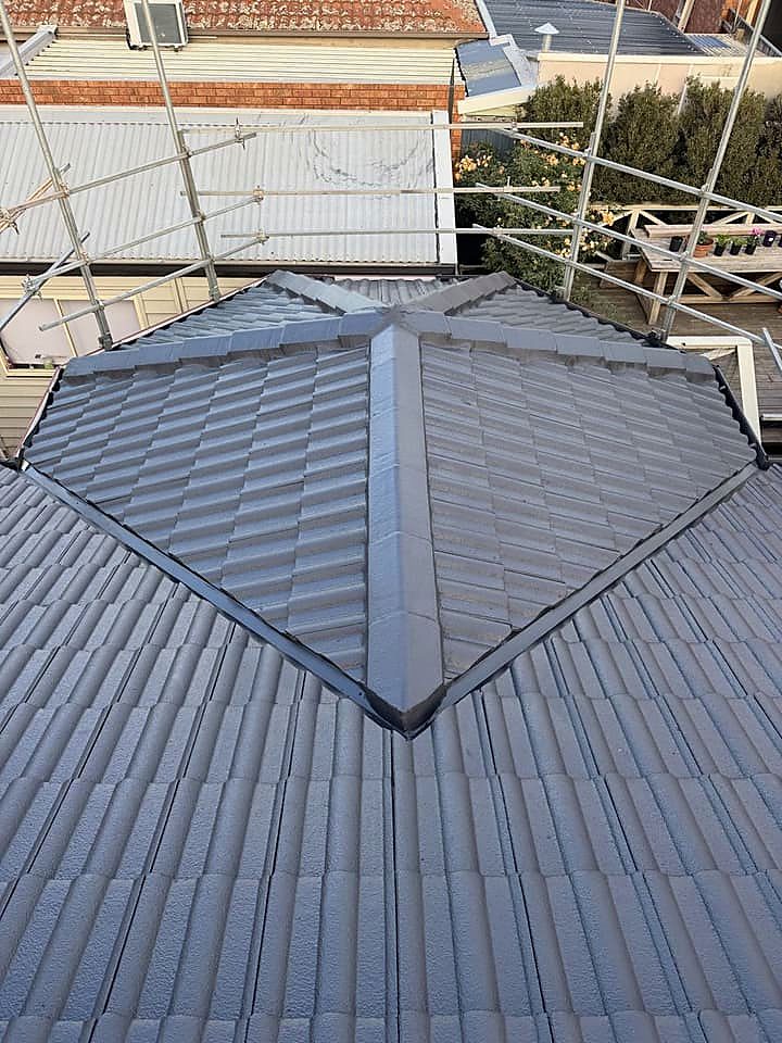 Charcoal concrete tile roof with crisp re-pointed ridges, finished by Y.M.I Roofing