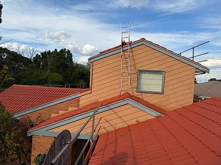 Terracotta tile roof after full restoration and resealing, photographed against a blue sky