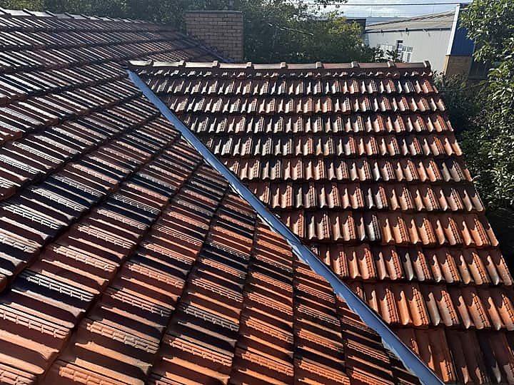Terracotta roof after repair, showing a clean valley and sharp ridge lines